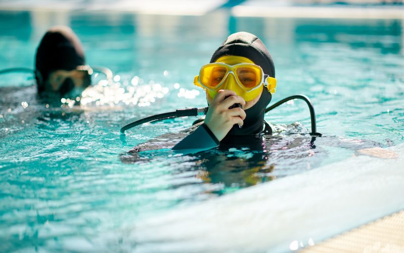 Female diver and male divemaster, dive lesson Female diver and male divemaster, dive lesson